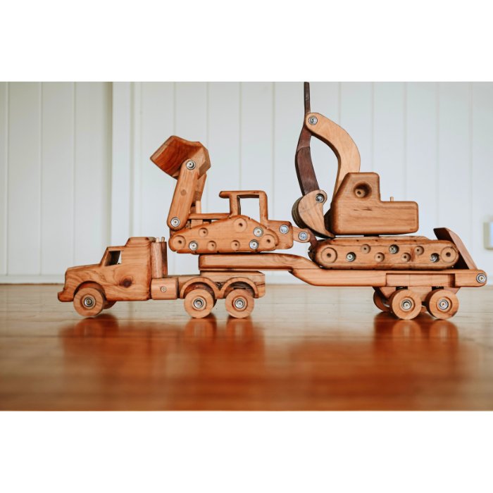 A set of heirloom quality, durable handmade wooden construction toy vehicles. Low loader truck hauling bulldozer and excavator on float trailer. Made from premium cedar. Big, chunky, functional design. 