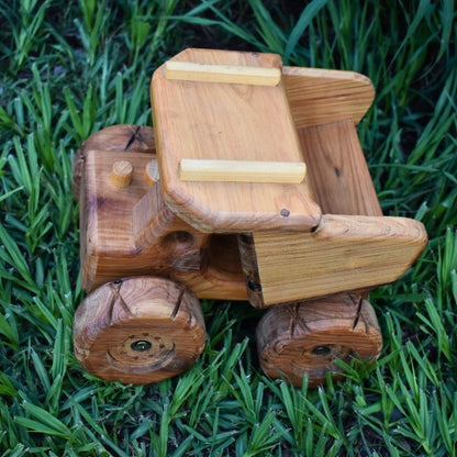 Looking down on a quality handmade wooden dump truck. Showcasing detail and heirloom quality. Sturdy design with chunky tread and smoke stacks. Wood grain resulting in premium luxury look.