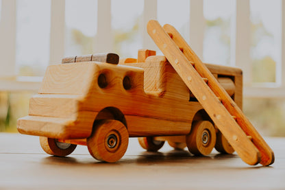 A durable and chunky handmade wooden fire truck, showcasing removable ladder, and detail of craftmanship.  